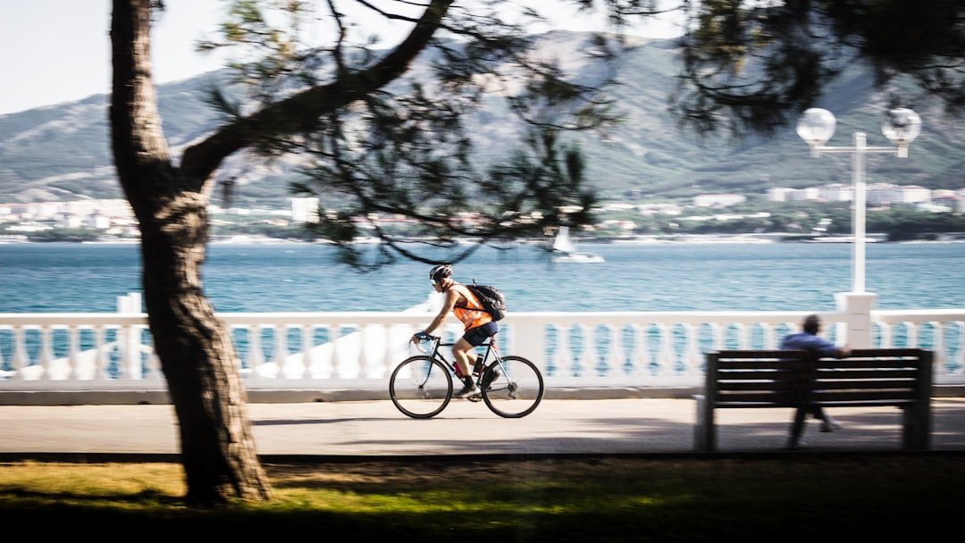 Man cycling along the waterfront promenade