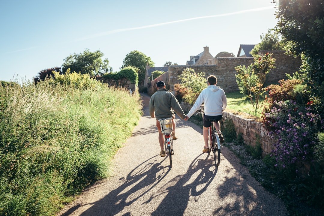 Couple holding hands while cycling on a sunny day