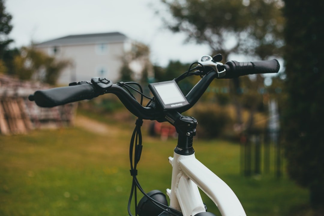 white and black bicycle on green grass field during daytime
