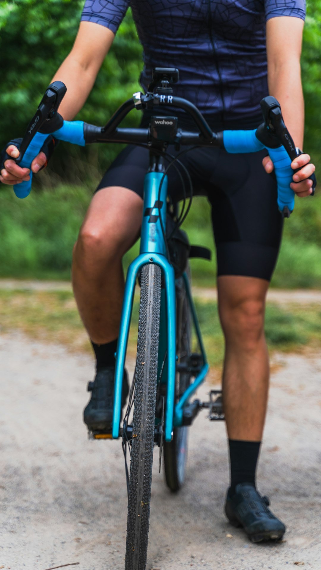 a man riding a bike down a dirt road