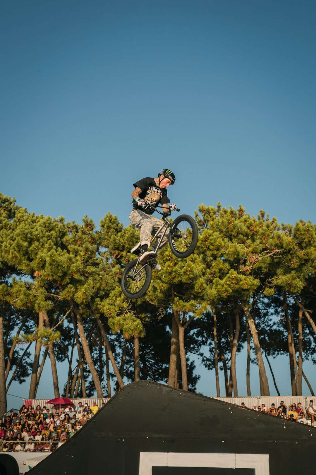 a man flying through the air while riding a bike