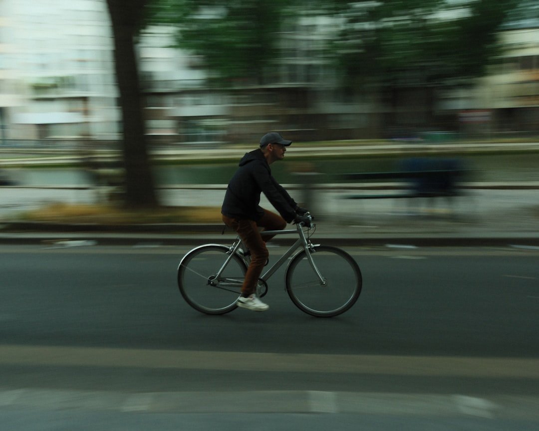 A cyclist rides a bike on a city street.