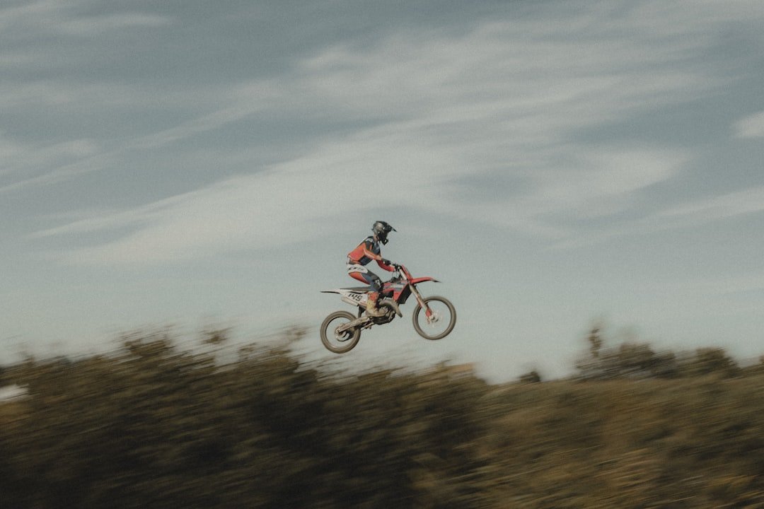 A motocross rider is mid-air.