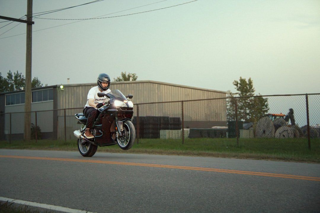 A man riding a motorcycle down a street