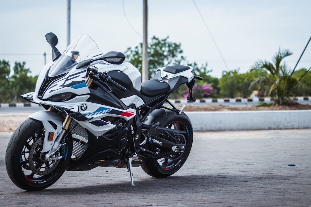 a white and black motorcycle parked in a parking lot