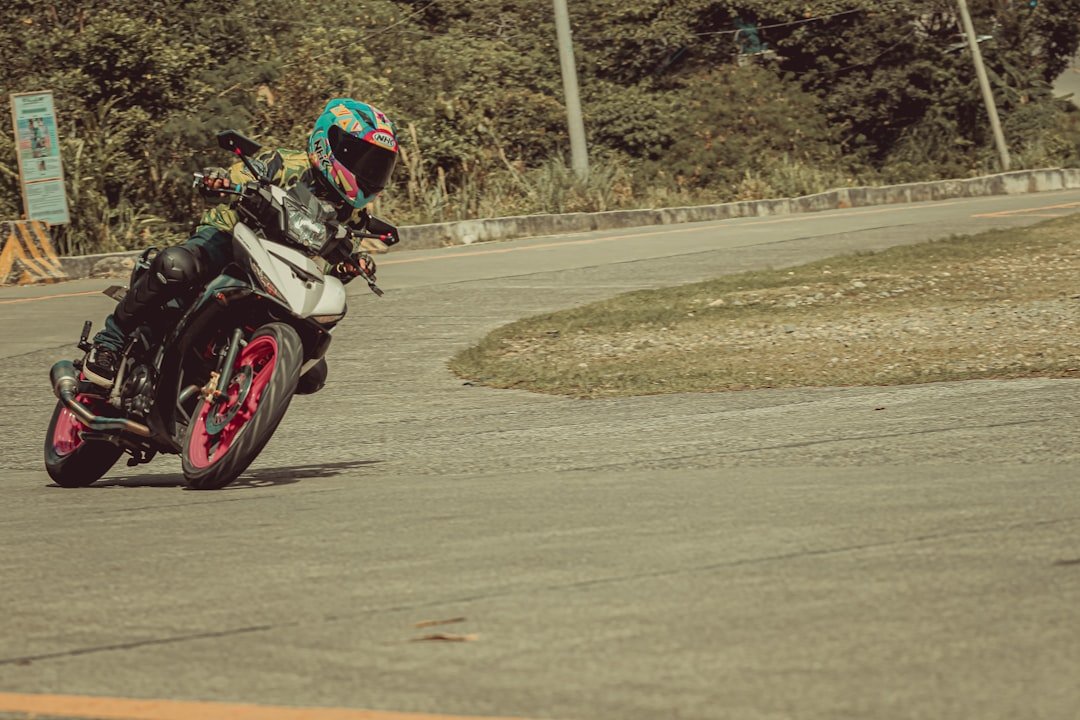 man riding motorcycle on road during daytime