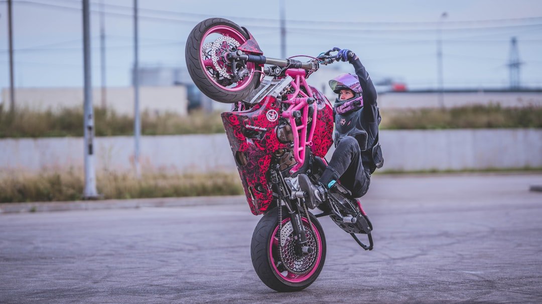 A person on a motorcycle doing a wheelie