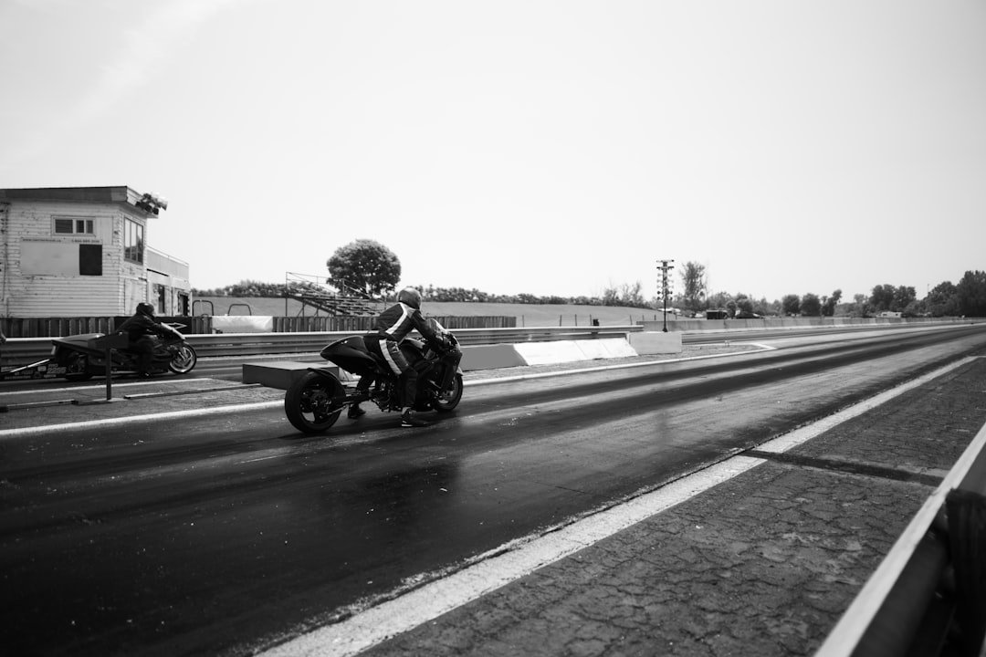 A motorcycle races on the drag strip.