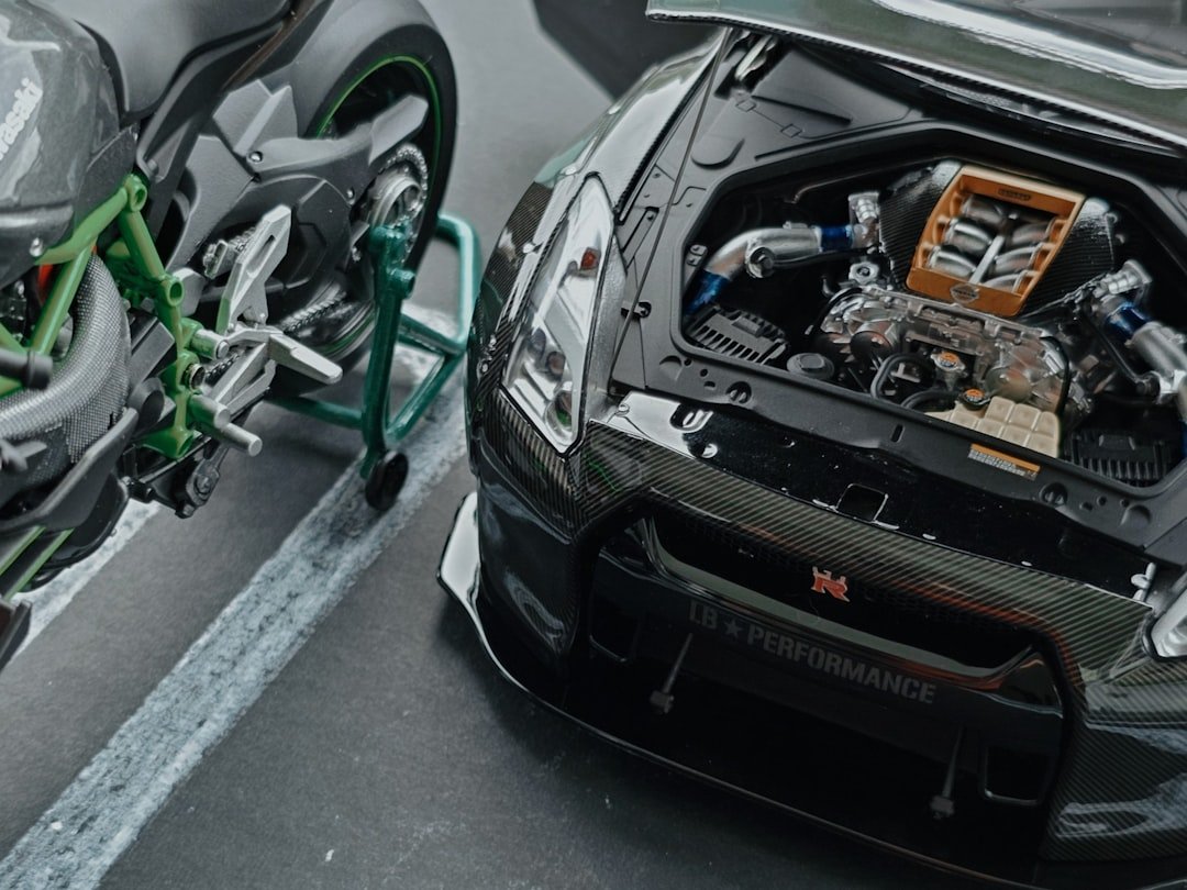 A sporty car is next to a motorcycle.