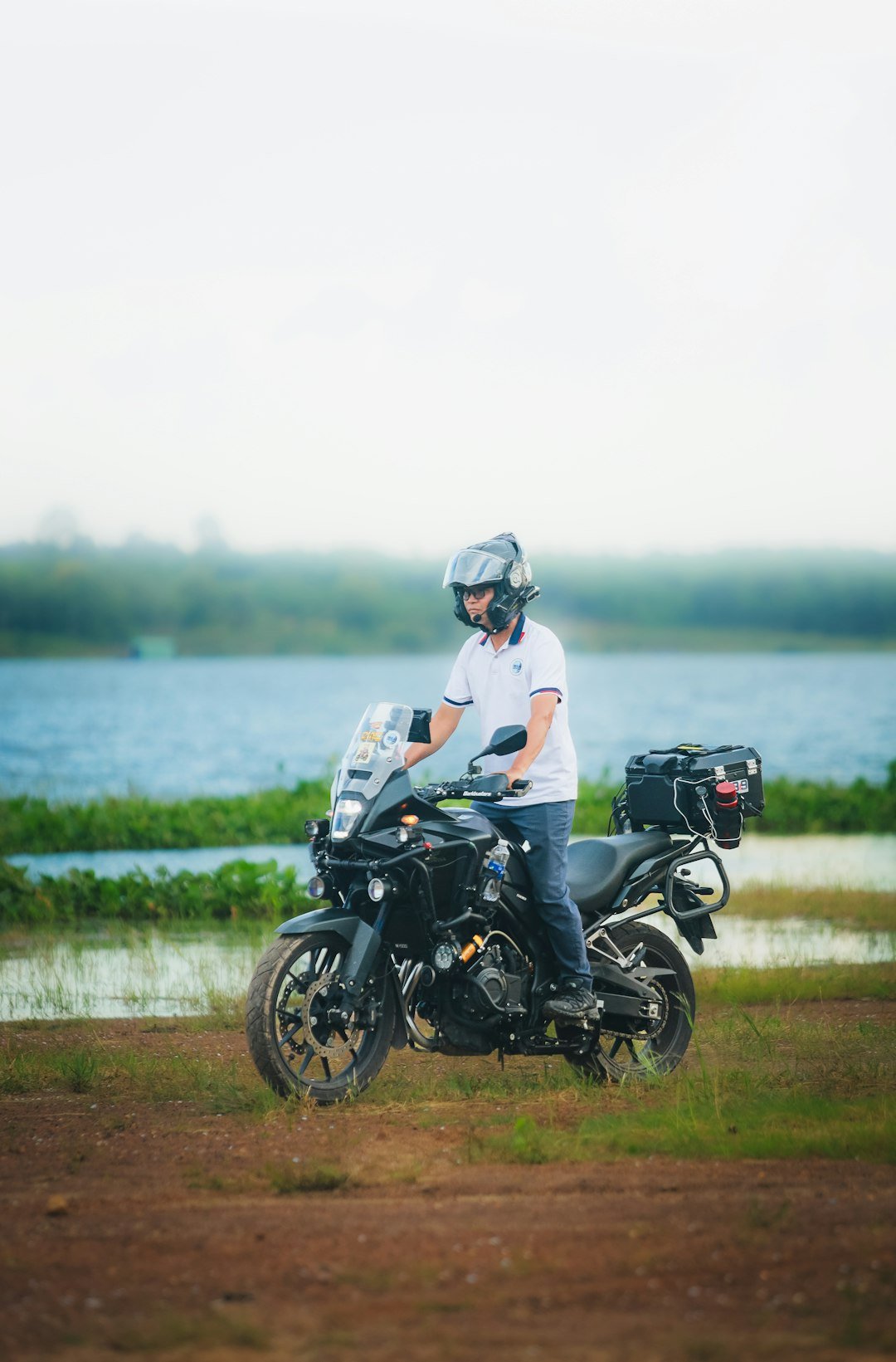 Man in helmet sitting on a black adventure motorcycle