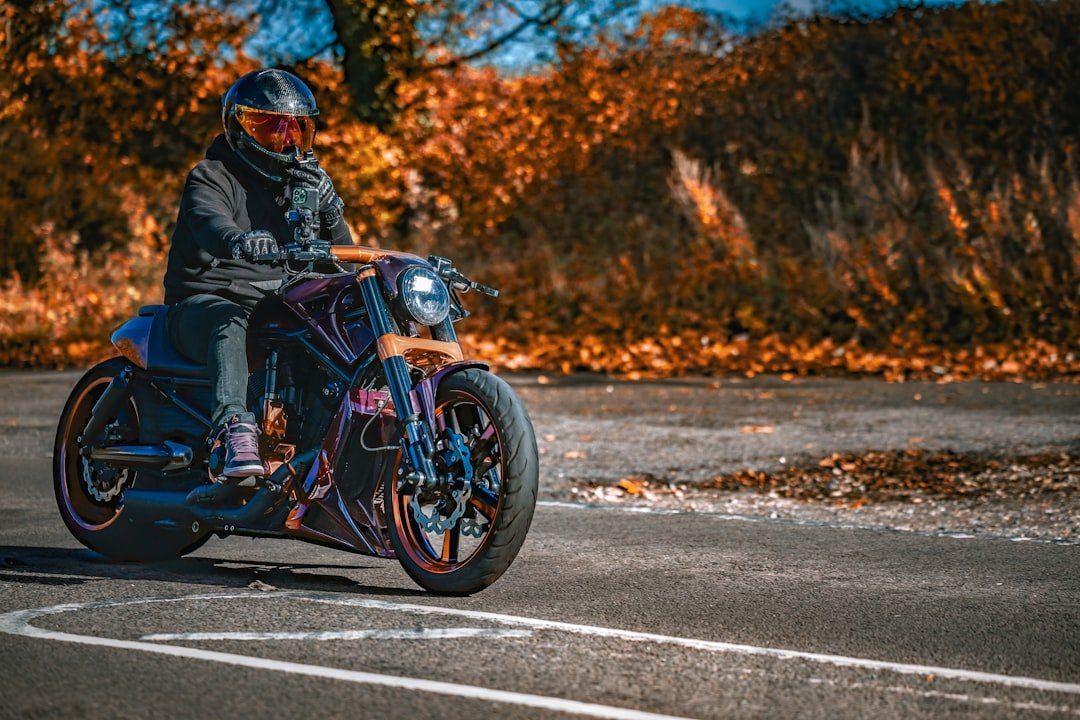 Rider on custom motorcycle with autumn foliage