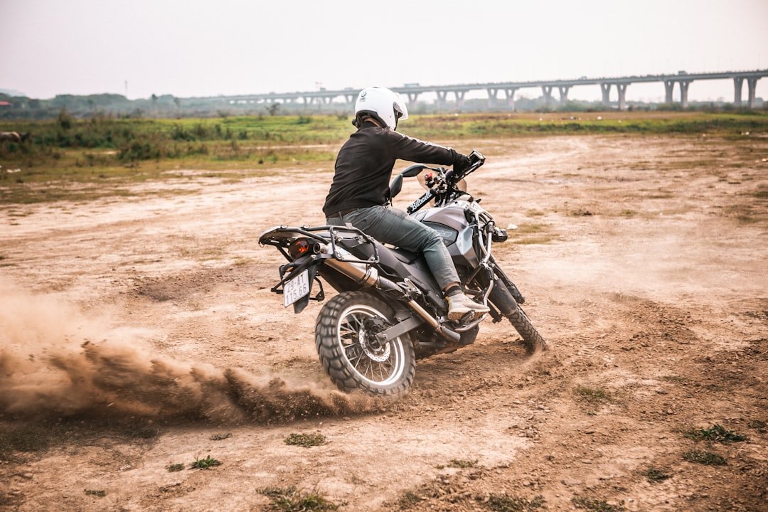 a person riding a dirt bike on a dirt road