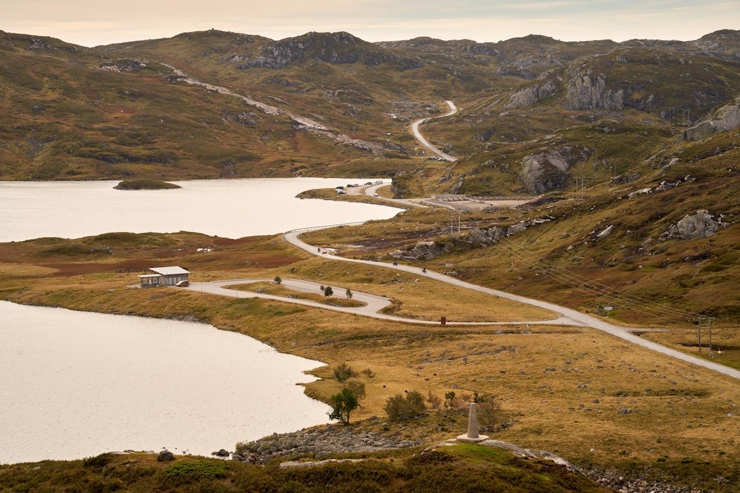 Winding road through a hilly landscape with lakes