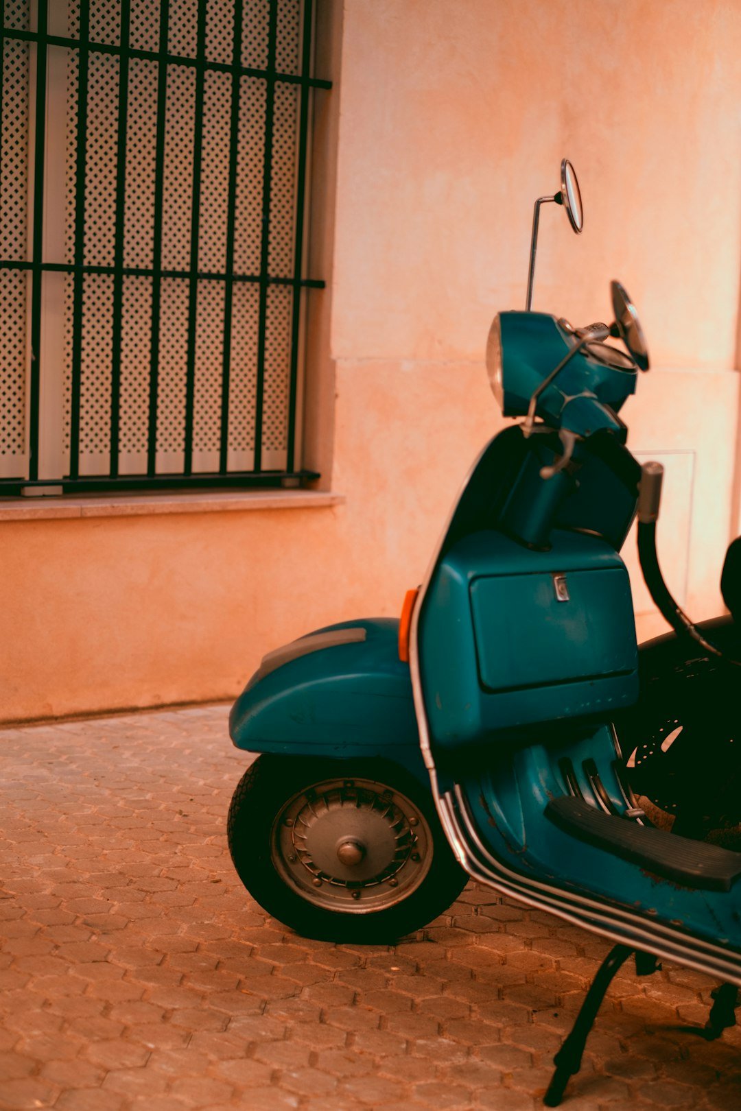 a blue motorcycle parked in front of a building