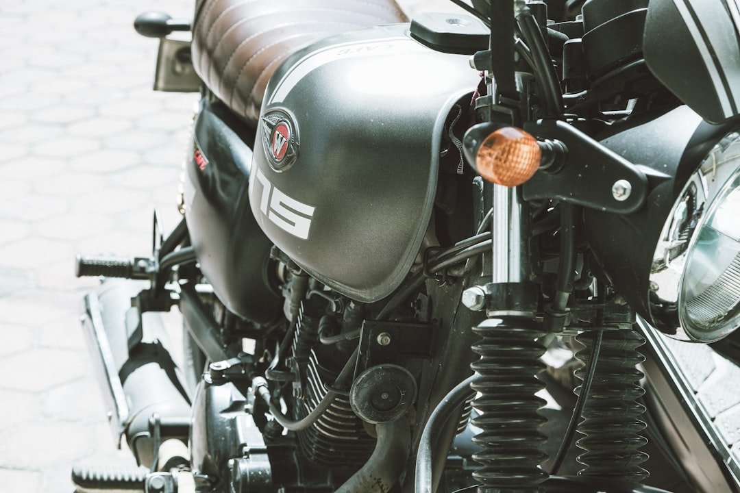 Close-up of a vintage motorcycle's fuel tank and handlebars.