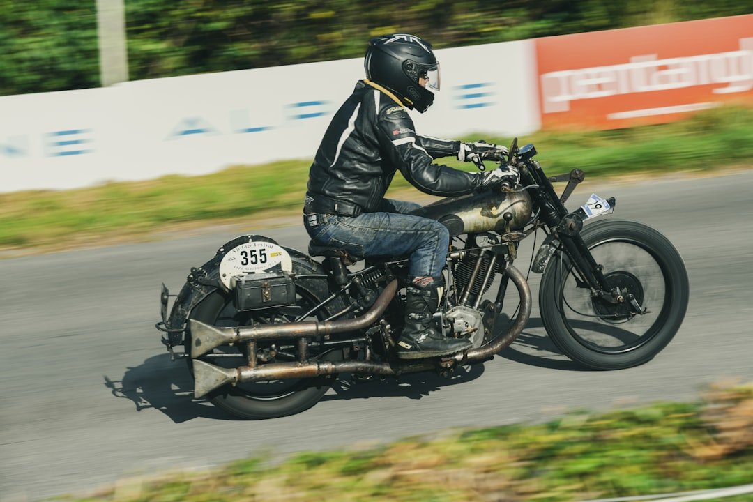 Man riding vintage motorcycle on a road