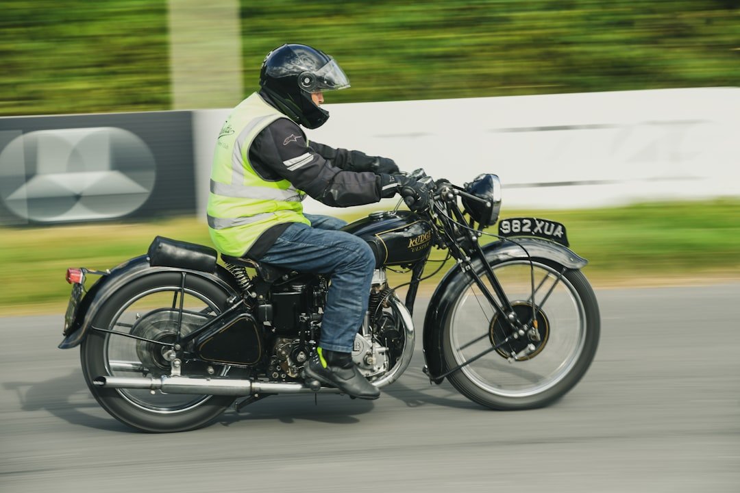 Man riding a vintage motorcycle on a track