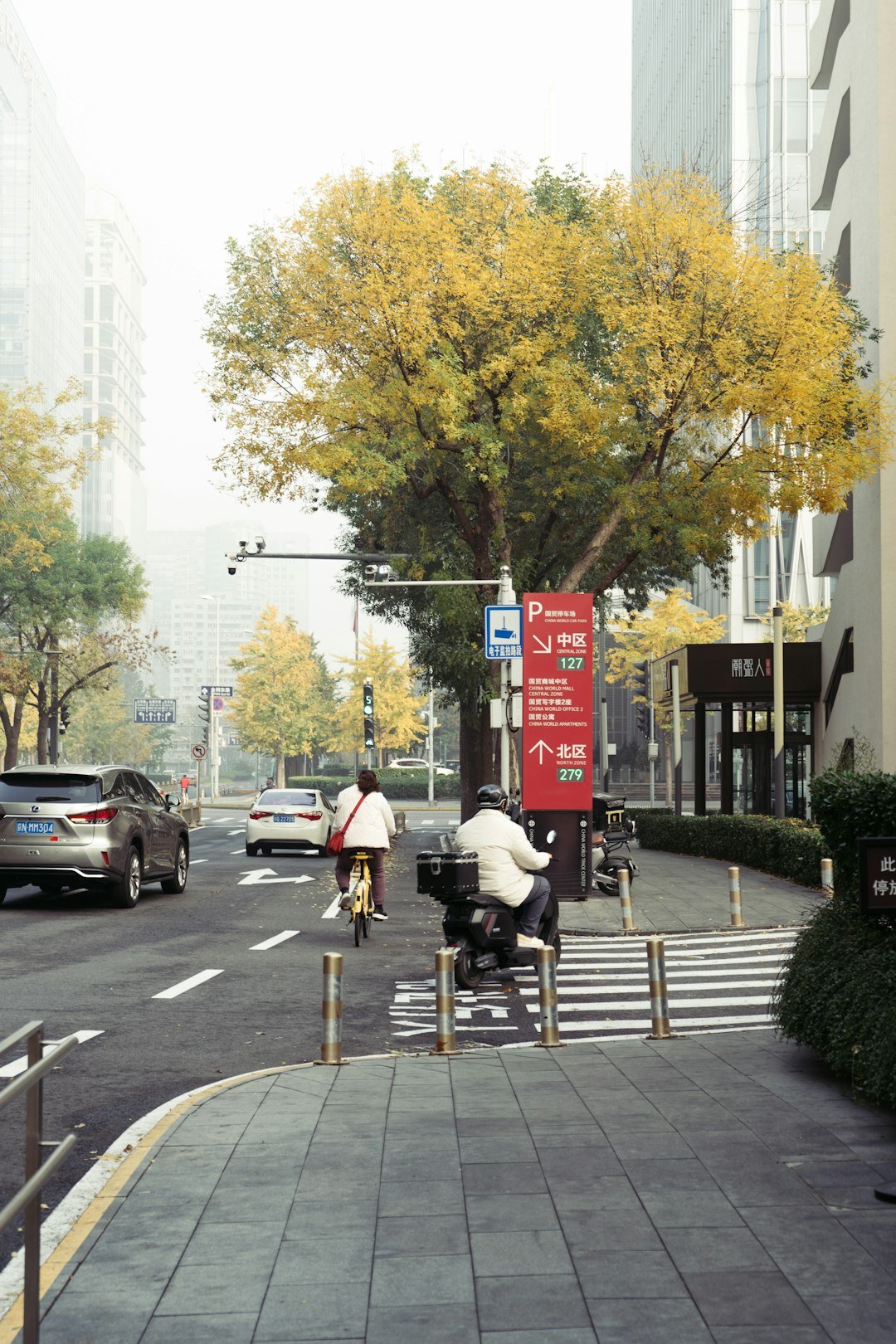 A couple of people riding bikes down a street