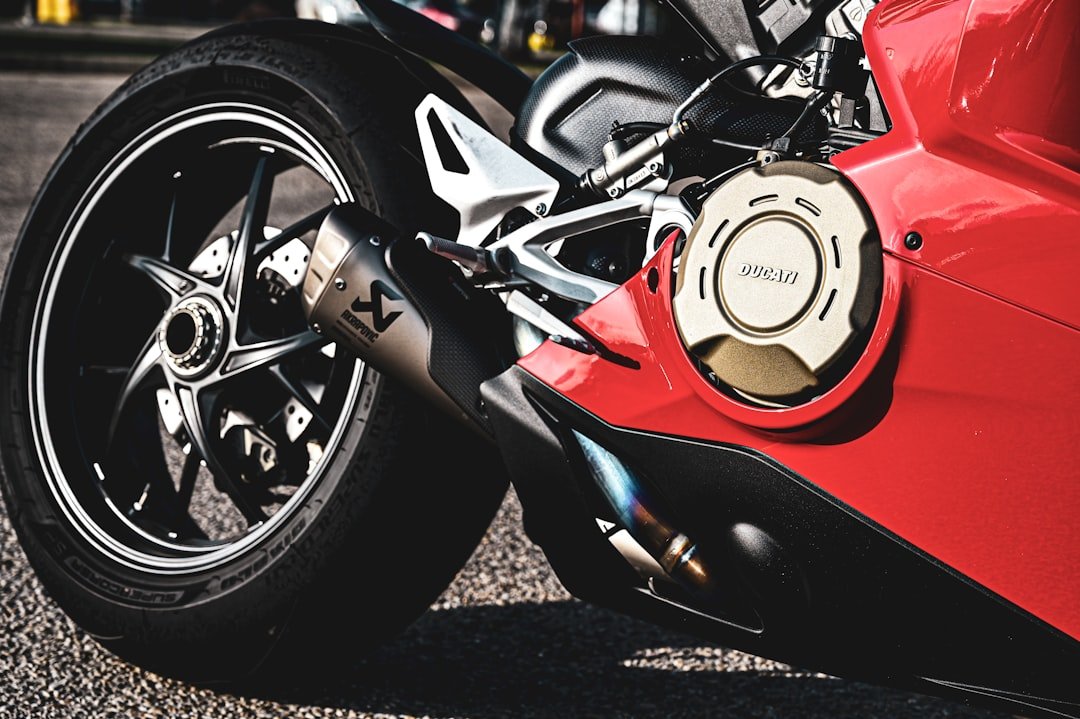 a close up of a red motorcycle parked on a street