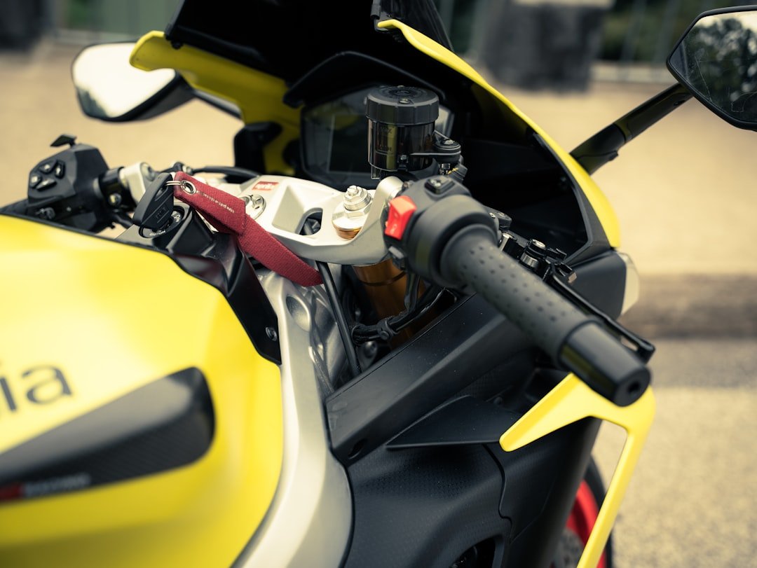 Close-up of a yellow motorcycle handlebar and handlebars