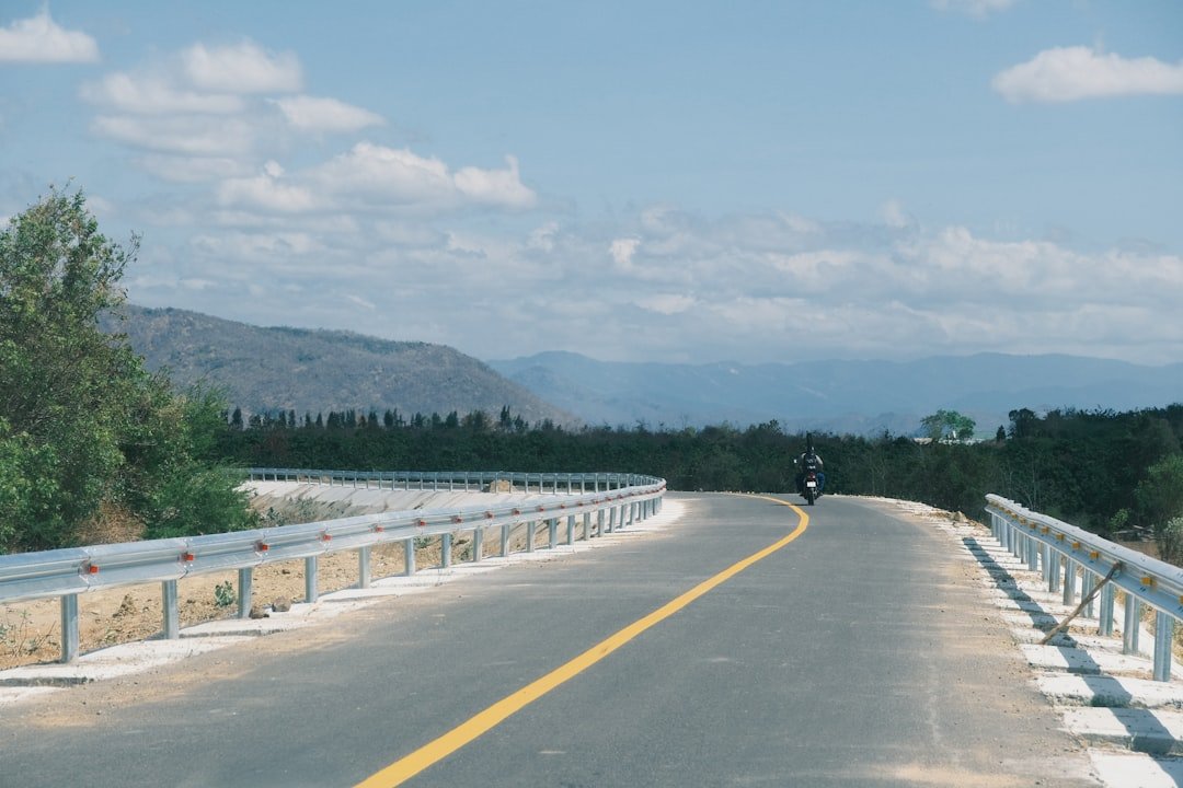 a person riding a motorcycle down a road