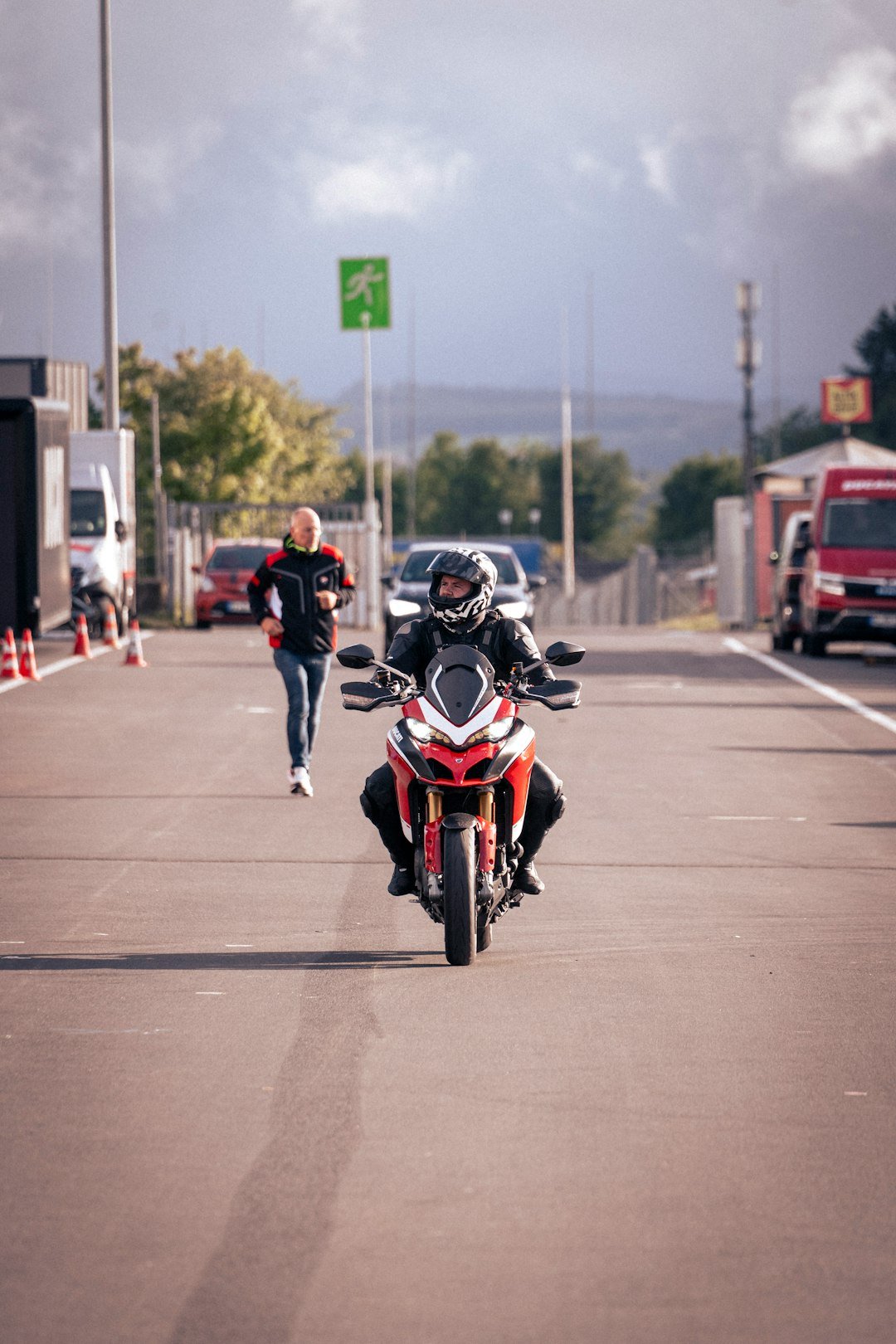 A motorcyclist rides down a road.